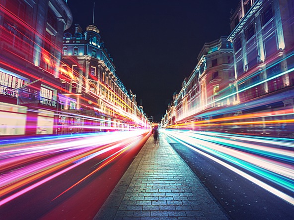 London street at night with long exposure light trails from traffic